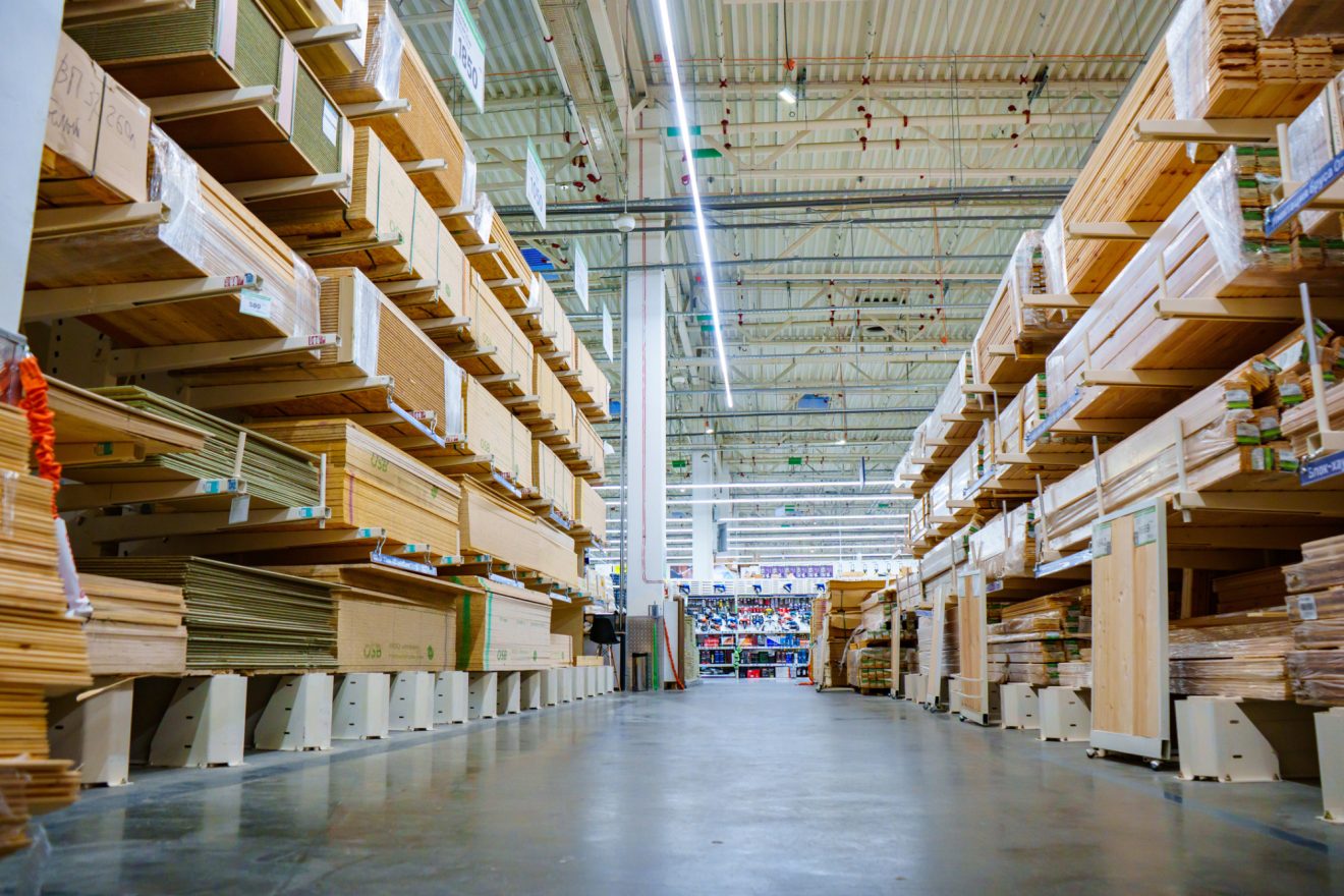 Racks with wooden boards and slabs in the warehouse of the hardware store