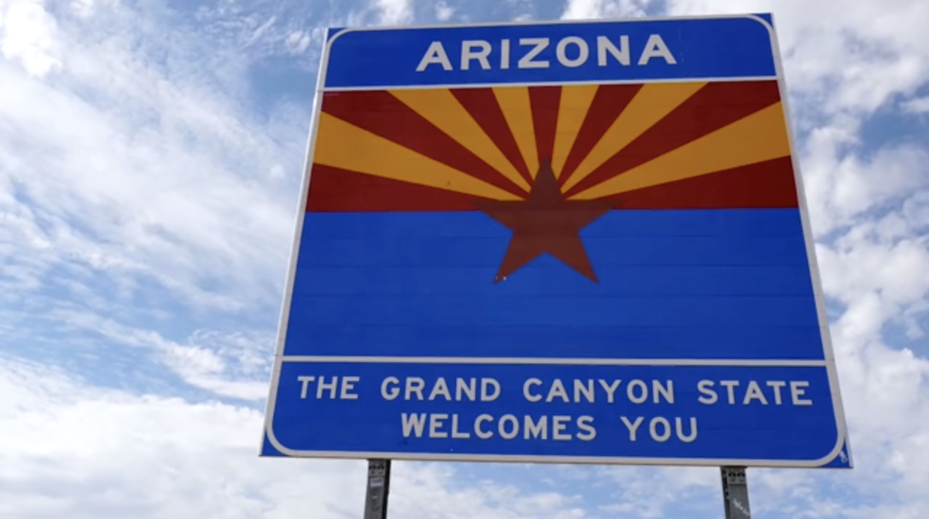 Screenshot from a video of a State of Arizona welcome sign with the message, "The Grand Canyon state welcomes you," below.