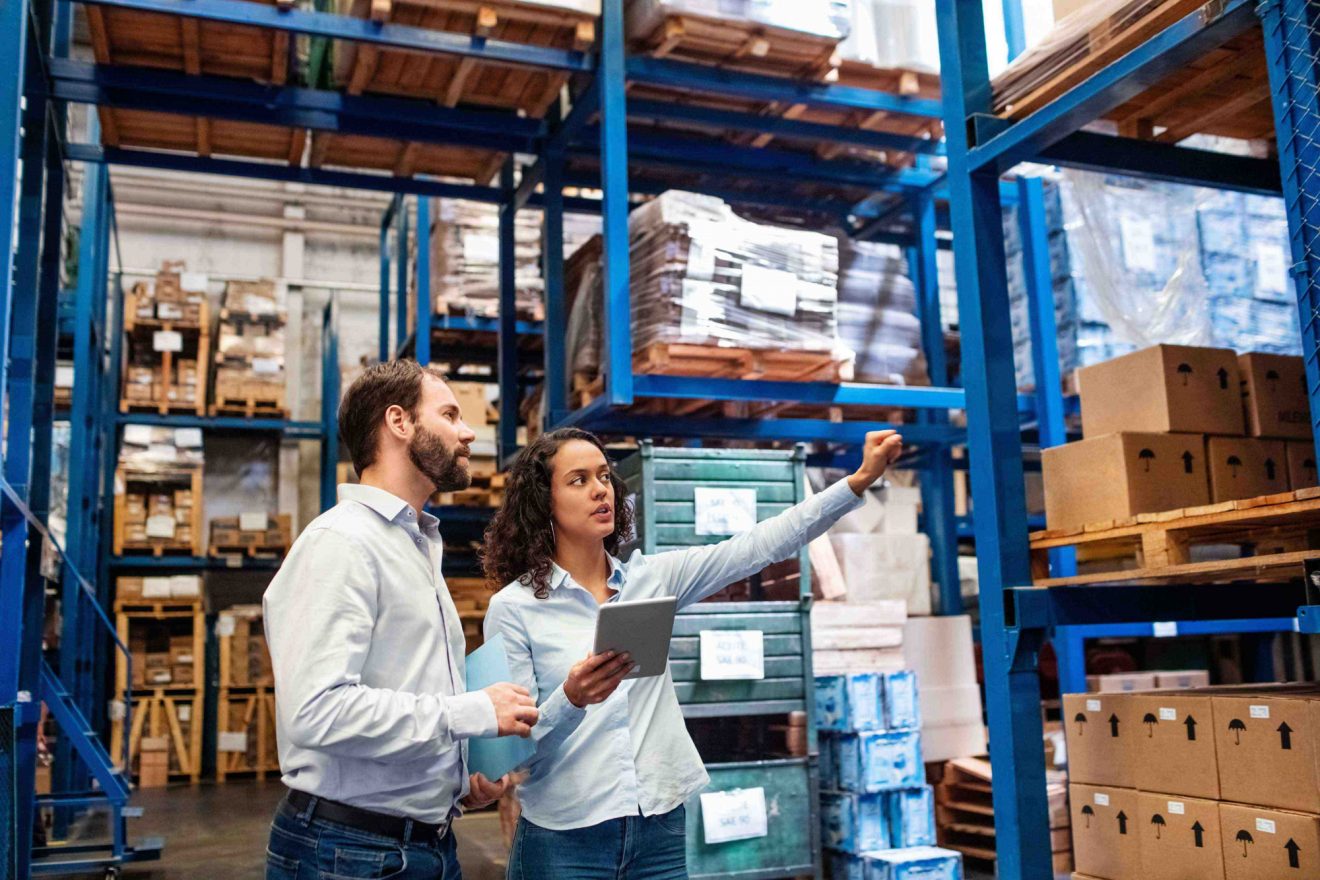 People discussing inventory in a warehouse